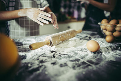 Midsection of person preparing food at kitchen