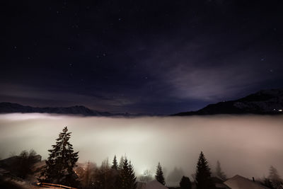 Scenic view of mountains against sky at night