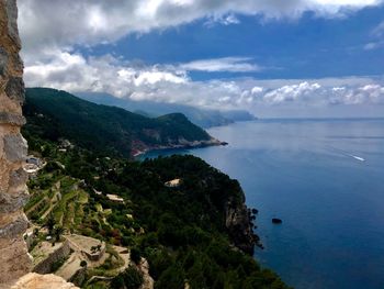 Scenic view of sea and mountains against sky