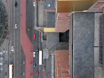 High angle view of cars on road by buildings in city