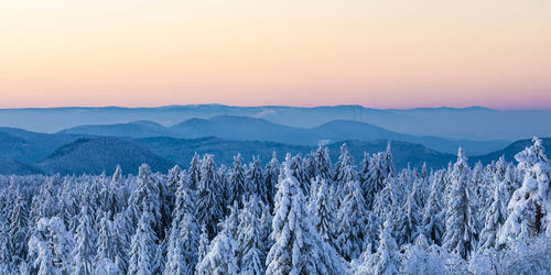 Panoramic view of snowcapped mountains against sky during sunset