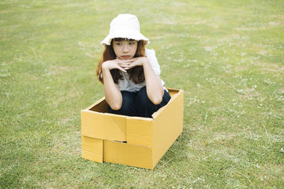 Portrait of cute girl sitting on grass