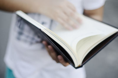 Close-up of hand holding book