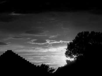 Low angle view of silhouette trees against sky