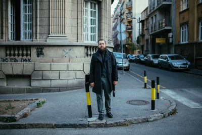 Man standing on street in city