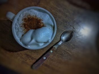High angle view of coffee on wooden table