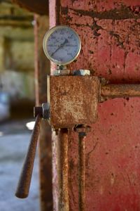 Close-up of pressure gauge in abandoned factory