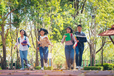 People running on land against trees