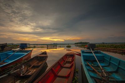 High angle view of boats moored in sea at sunset