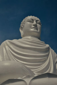 Low angle view of statue against blue sky