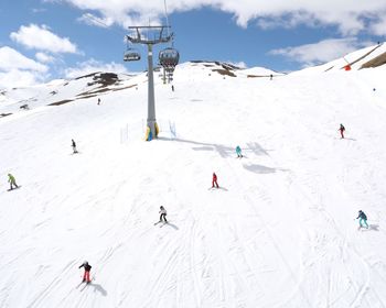 People skiing on snowcapped mountain