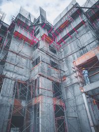 Low angle view of construction site against buildings in city