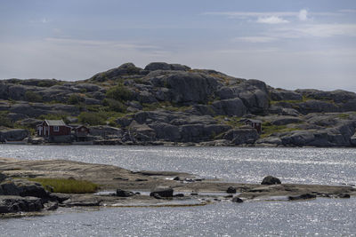 Rocks by sea against sky