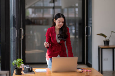 Woman working on table at home