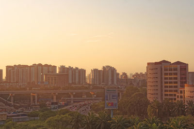 Buildings in city at sunset