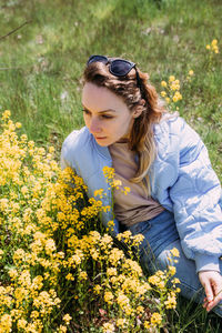 Portrait of young woman standing amidst plants