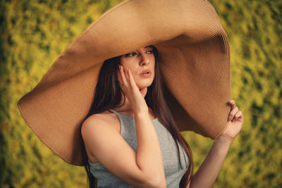 Young beautiful woman with big summer hat