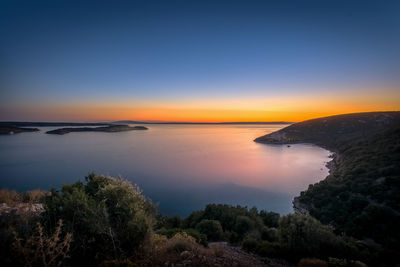 Scenic view of sea against clear sky during sunset