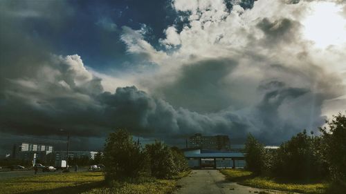 Panoramic shot of trees and buildings against sky