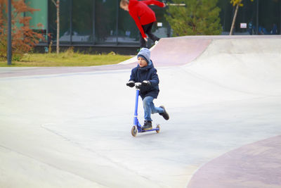 Full length of boy on push scooter