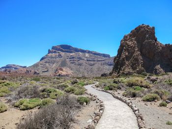 Scenic view of mountains against clear blue sky