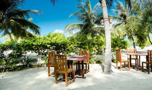 Outdoor tables set for breakfast on pristine white sand, maldives