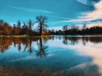 Reflection of trees in lake against sky