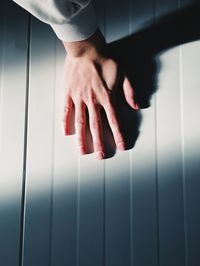 Close-up of hand on wall