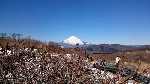 Scenic view of mountains against clear blue sky