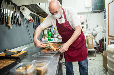 Baker wearing a mask and serving balkan food in belgrade,serbia