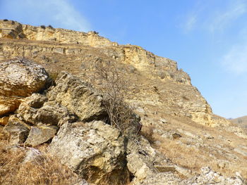 Low angle view of rock formation against sky