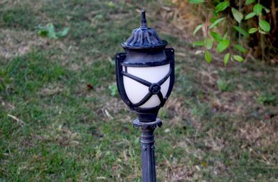 Close-up of electric lamp on field