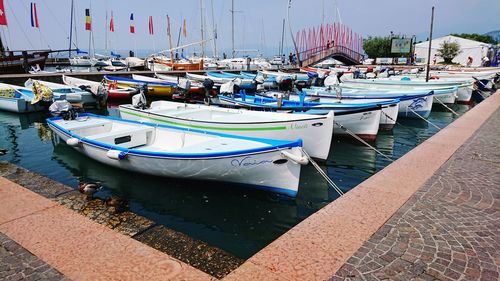 Boats moored at harbor in city