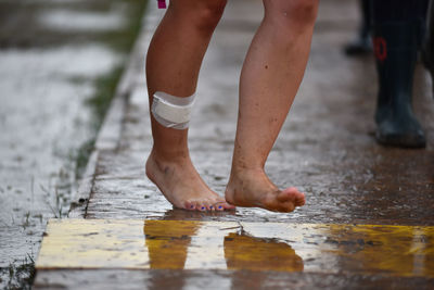 Injured barefoot woman on street