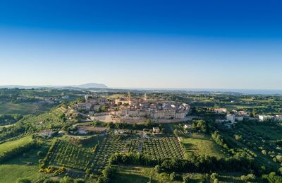 Aerial view of landscape against clear blue sky