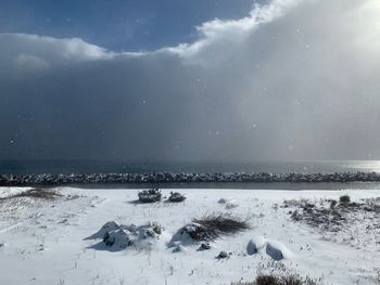 Scenic view of sea against sky during winter