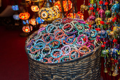 Close-up of bracelets and illuminated lanterns in market