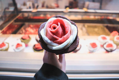 Close-up of hand holding ice cream