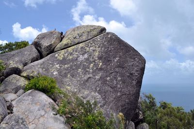 Low angle view of rock formation against sky