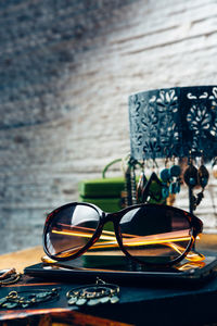 Close-up of eyeglasses on table against wall