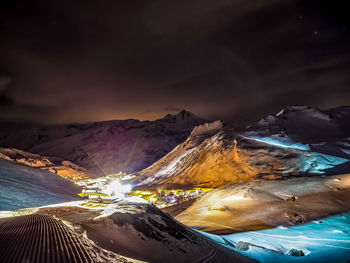 Aerial view of snowcapped mountains against sky during winter