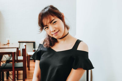 Portrait of smiling woman sitting in cafe