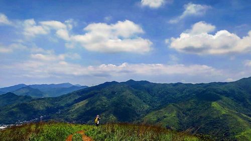 Scenic view of mountains against cloudy sky