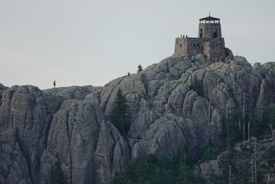 Low angle view of rock formations against sky