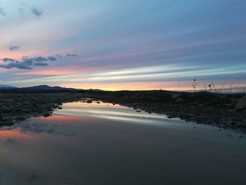 Scenic view of beach against sky during sunset