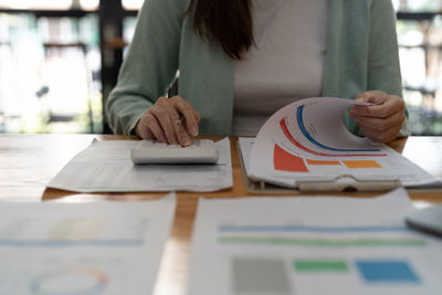 Midsection of businesswoman working at office