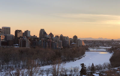 Buildings in city against sky during winter