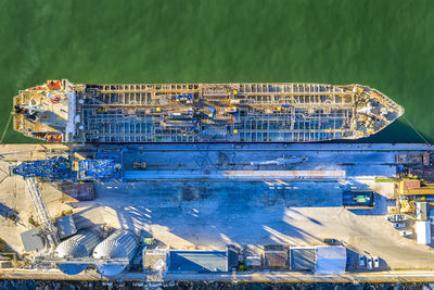 High angle view of harbor by sea against blue sky