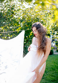 Side view of bride holding bouquet