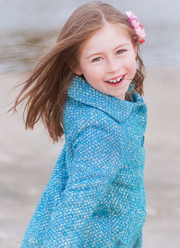 Portrait of smiling girl against sky